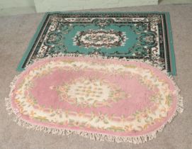 Two rugs to include pink floral oval example and green floral Komfort example.