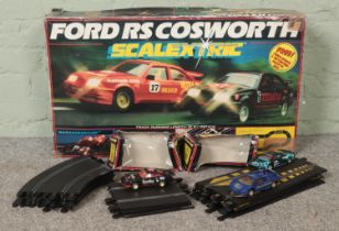 A Scalextric Ford RS Cosworth set, together with additional track and three extra cars; including