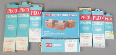 Seven boxed Peco Streamline Flexible Trackage System along with a boxed Peco Office Building set.
