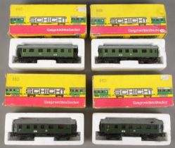 Four boxed Schicht HO gauge model railway carriages.