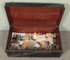 A tin trunk of vintage monochrome photographs. Includes some military examples, etc.