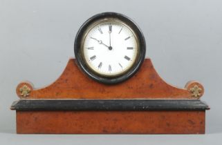 A walnut and ebonised drum mantle clock, with brass Fleur de Lys to the rounded shoulders. Featuring