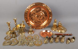 A collection of mostly novelty brass and copper to include duck figure group, candlesticks, shoes,
