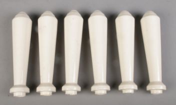 A set of six ceramic beer pump handles. 23cm long. Chip to the base of one example.