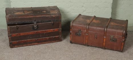 Two wooden bound vintage trunks to include dome topped example. Lid to dome topped example is