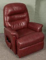 A Sherborne red leather electric reclining armchair.