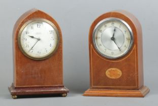 Two mahogany cased mantle clocks, one of lancet form raised on brass bun feet, with dial stamped for