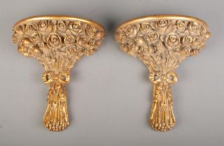 A pair of decorative gilt composite wall shelves modelled as a bouquet of roses. Height: 32cm,