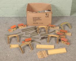 A box of Hornby Dublo railway accessories. Includes track, bridges, buildings, etc.