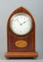 An Edwardian mahogany cased lancet mantle clock, raised on bun feet and with banded inlay and