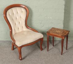A balloon back chair with deep button upholstery along with a small ornate sewing box.