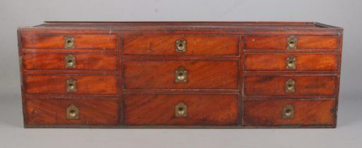 A mahogany fronted bank of ten drawers, with finger loop handles. Possibly from the interior of a
