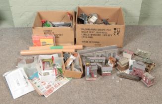 Two boxes of model railway scenery and buildings.