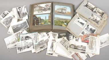 A box of mostly monochrome postcards and photographs depicting trams and buses.