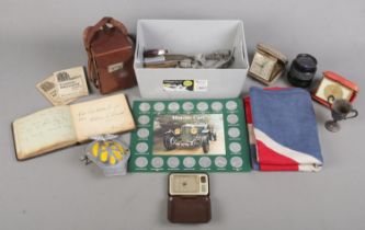 A box of collectables. Includes Voigtlander Brilliant camera, autographs, AA car badge, medals,