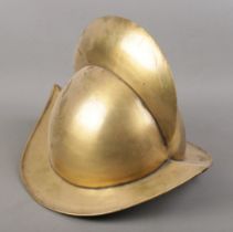 A Spanish Morion style brass helmet.