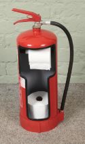 A fire extinguisher converted into novelty toilet roll holder.