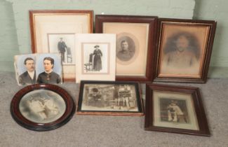 A collection of framed photographs including several antique examples.