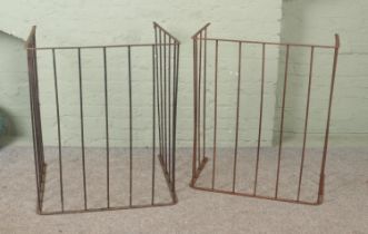 A pair of Edwardian iron nursery fire fenders.