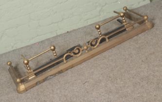 A brass non-extending fire fender along with a similar two piece fender.