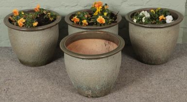 Four glazed garden planters.