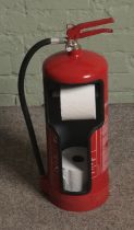 A fire extinguisher converted into novelty toilet roll holder.