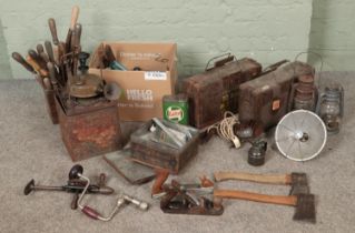 A collection of assorted tools and lamps to include S.H&S camping stove, chisels, ammo crates,