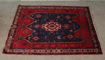 A large ground wool rug featuring central medallion surrounded by flora and fauna. Approx.