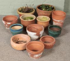 A quantity of garden planters. Includes terracotta example, etc. Some examples are cracked.