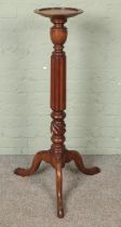 A mahogany plant stand with reeded pedestal and triform base. Hx112cm