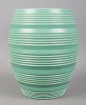 Keith Murray for Wedgwood; a ribbed green vase in matt green. Stamped to the base. 16.5cm tall.