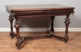 A carved oak table with lion mask decoration to all four corners. Height 73cm, Top 90cm x 123cm.