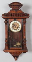 A carved mahogany 8 day wall clock for restoration. Finial loose, missing hand, etc.