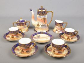 A Noritake part coffee service desert scene. Includes coffee pot, four cups and five saucers,