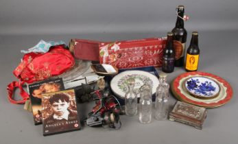 A box of mixed collectables including cut glass dishes, fishing reels, tin plates, metal boats and