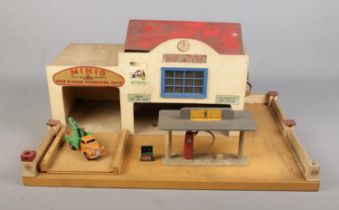A Minic Service station along with a Dinky Toys Commer service truck. (29cm x 61cm)