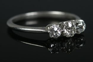An early 20th century platinum three stone diamond ring. Central diamond approximately 0.25ct.