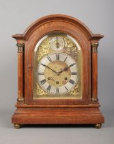 An oak cased Gustav Becker bracket clock. With brass dial, Roman numeral markers and subsidiary dial