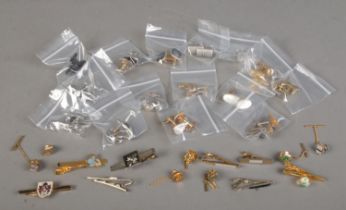 15 pairs of cufflinks and 15 tie pins and tacks