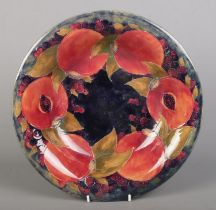A Moorcroft pottery bowl decorated in the Pomegranate design. Signed to base and impressed M68.