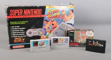 A boxed Super Nintendo console system, containing Street Fighter II and three additional games