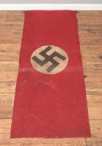 A World War Two period German Nazi Party flag. Red ground with swastika to both sides. 185cm x 72cm.