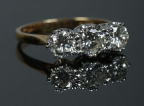 An 18ct gold three stone diamond ring. Approximately 1.9ct diamond in total. Has original sale