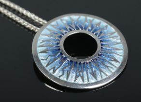 An enamelled silver Runic pendant on silver chain by Sheila Fleet, Orkney. Diameter of pendant 37mm,