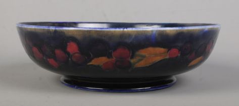 A Moorcroft pottery bowl decorated in the Pomegranate design. Signed to base and impressed M88.