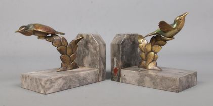 A pair of bronze and marble book ends, surmounted with exotic birds.