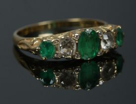 An 18ct gold diamond and emerald five stone ring. Hallmarks for 1976. Approximately 0.5ct total