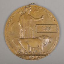 A World War One bronze memorial plaque/death penny awarded to B Abdul Rasool. Soldered hook to