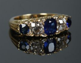 A gold, diamond and sapphire five stone ring. Each diamond just over 1ct. Tests as high carat