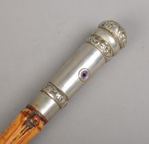 An antique bamboo sword stick. With white metal pommel and collar. The pommel set with two small